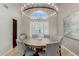 Elegant dining room featuring a round table, chandelier, and plantation shutters at 15237 S 19Th Way, Phoenix, AZ 85048