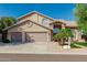 Charming two-story home with a three-car garage, neutral paint, well-maintained landscaping, and arched windows creating curb appeal at 15237 S 19Th Way, Phoenix, AZ 85048