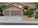 Charming home featuring a three-car garage, desert landscaping, and an arched entryway at 15237 S 19Th Way, Phoenix, AZ 85048