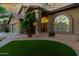 Charming home featuring an arched window and entryway, desert landscaping, and a three-car garage at 15237 S 19Th Way, Phoenix, AZ 85048