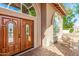 Beautiful wood front door with decorative windows and seating area on covered front porch at 15237 S 19Th Way, Phoenix, AZ 85048