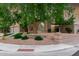 Charming home featuring manicured desert landscaping, a large tree and privacy wall at 15237 S 19Th Way, Phoenix, AZ 85048