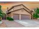 Home with a two-car garage, brick driveway, and desert landscaping on a beautiful day at 15237 S 19Th Way, Phoenix, AZ 85048