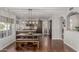 Open-concept kitchen featuring dark wood cabinets, granite countertops, and a dining area at 15237 S 19Th Way, Phoenix, AZ 85048