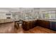 Spacious kitchen featuring wood floors, granite countertops, and modern lighting at 15237 S 19Th Way, Phoenix, AZ 85048