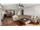 Spacious living room with hardwood floors, sofa, and seamless connection to the kitchen at 15237 S 19Th Way, Phoenix, AZ 85048