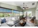 The light-filled living room offers hardwood floors, a ceiling fan, and multiple windows at 15237 S 19Th Way, Phoenix, AZ 85048