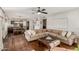 Comfortable living room with hardwood floors, a ceiling fan, and plenty of natural light at 15237 S 19Th Way, Phoenix, AZ 85048
