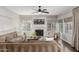 Bright living room with a cozy fireplace, plush seating, and many windows at 15237 S 19Th Way, Phoenix, AZ 85048