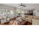 Bright living room featuring hardwood floors, stylish furniture, and backyard views at 15237 S 19Th Way, Phoenix, AZ 85048