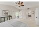 Spacious main bedroom with light carpet, ceiling fan, and access to a private balcony at 15237 S 19Th Way, Phoenix, AZ 85048