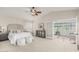 Bright main bedroom featuring high ceilings, a ceiling fan, and access to a sitting area at 15237 S 19Th Way, Phoenix, AZ 85048