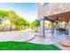 Spacious covered patio with stone flooring, ceiling fan, and views of the landscaped yard at 15237 S 19Th Way, Phoenix, AZ 85048