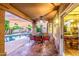 Covered patio boasts a dining area, stone floors, ceiling fan, and a gorgeous pool view at 15237 S 19Th Way, Phoenix, AZ 85048