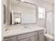 Bright bathroom featuring a vanity with a stone countertop, large mirror, and shower at 155 N Lakeview Blvd # 268, Chandler, AZ 85225
