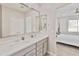 Modern bathroom featuring double sinks and view to bedroom at 155 N Lakeview Blvd # 268, Chandler, AZ 85225