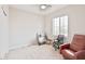 Neutral bedroom with carpet, ceiling fan, window, and a comfortable recliner chair at 155 N Lakeview Blvd # 268, Chandler, AZ 85225