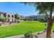 Expansive green lawn area with a playground; condos feature balconies and neutral colors at 155 N Lakeview Blvd # 268, Chandler, AZ 85225