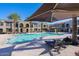 Community pool with lounge chairs and umbrellas for a relaxing outdoor experience at 155 N Lakeview Blvd # 268, Chandler, AZ 85225