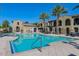 Inviting community pool features palm trees, lounge area, and a grilling area for residents at 155 N Lakeview Blvd # 268, Chandler, AZ 85225