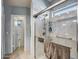 Updated bathroom featuring tiled walk-in shower, grab bar, and linen storage at 15558 N Ulrich Way, Surprise, AZ 85374