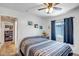 Comfortable bedroom features neutral colors, ceiling fan, and natural light at 15558 N Ulrich Way, Surprise, AZ 85374