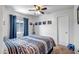 Cozy bedroom with a ceiling fan, natural light, and neutral decor at 15558 N Ulrich Way, Surprise, AZ 85374
