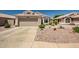 Charming single-story home with a well-maintained desert landscape and a two-car garage at 15558 N Ulrich Way, Surprise, AZ 85374