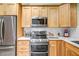 Modern kitchen with stainless steel appliances, ample cabinet space, and white backsplash at 15558 N Ulrich Way, Surprise, AZ 85374
