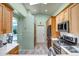 Charming kitchen with stainless steel appliances, tile backsplash, and skylight at 15558 N Ulrich Way, Surprise, AZ 85374