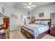 Comfortable main bedroom with a ceiling fan, carpet, and an en-suite bathroom at 15558 N Ulrich Way, Surprise, AZ 85374