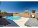 An inviting in-ground pool, surrounded by a lush landscape, offers the perfect outdoor retreat for relaxation at 15558 N Ulrich Way, Surprise, AZ 85374