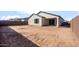 Unfinished backyard perfect for landscaping and outdoor activities at 16689 W Whispering Wind Dr, Surprise, AZ 85387