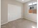 Cozy bedroom with sliding closet doors and natural light at 16689 W Whispering Wind Dr, Surprise, AZ 85387