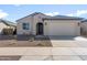 Charming single-story home with a well-maintained yard and a two-car garage in a residential neighborhood at 16689 W Whispering Wind Dr, Surprise, AZ 85387