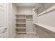 Bright walk-in closet with shelving and hanging rods for ample storage at 16689 W Whispering Wind Dr, Surprise, AZ 85387