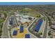 This aerial showcases a community school with solar panels and sports fields at 17235 W Statler St, Surprise, AZ 85388