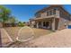 Large backyard with gravel accents, a small patch of grass and a covered patio at 17235 W Statler St, Surprise, AZ 85388