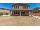 Backyard view featuring a covered patio, grill, and generous space for outdoor activities at 17235 W Statler St, Surprise, AZ 85388