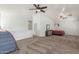 Spacious upper-level bedroom with carpet flooring, two ceiling fans, and ample natural light at 17235 W Statler St, Surprise, AZ 85388