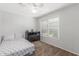 A bedroom with carpet flooring, light grey walls, a ceiling fan and a horizontal blind at 17235 W Statler St, Surprise, AZ 85388