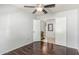 Bedroom with dark wood laminate flooring, ceiling fan, and a closet at 17235 W Statler St, Surprise, AZ 85388