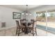 Dining area featuring a glass-topped table, upholstered chairs, and a sliding glass door to the yard at 17235 W Statler St, Surprise, AZ 85388