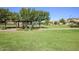 Community gazebo with green grass, trees, and walking path at 17235 W Statler St, Surprise, AZ 85388
