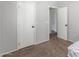 A carpeted hallway with two white doors and grey paint on the walls at 17235 W Statler St, Surprise, AZ 85388