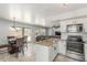 Open kitchen layout featuring stainless steel appliances and a view into the dining and living area at 17235 W Statler St, Surprise, AZ 85388