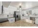 Bright kitchen featuring white cabinets, stainless steel appliances, and granite countertops at 17235 W Statler St, Surprise, AZ 85388