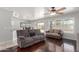 Open floor plan with living room, dining area, and kitchen with dark wood floors at 17235 W Statler St, Surprise, AZ 85388
