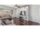 Living room featuring dark wood flooring, a ceiling fan, and a fireplace at 17235 W Statler St, Surprise, AZ 85388