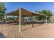 Shaded playground with slides and swings, surrounded by trees and landscaping at 17235 W Statler St, Surprise, AZ 85388